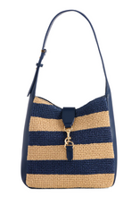 Cargar imagen en el visor de la galería, Navy and beige striped handbag with a bow detail on a white background